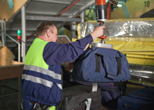 Vaculex Baggage Handling - Loading Baggage from Chute to Open Cart